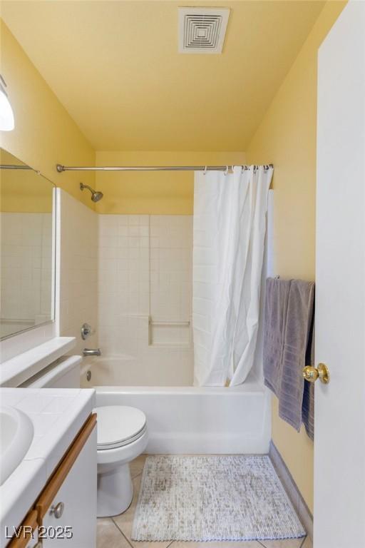 full bathroom with tile patterned floors, toilet, vanity, and shower / bath combo