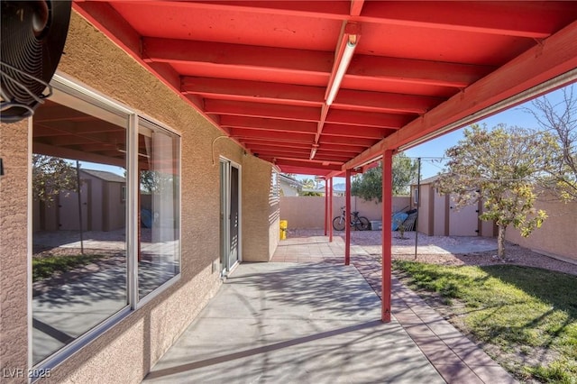 view of patio featuring a storage shed