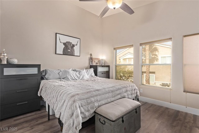 bedroom with ceiling fan, dark hardwood / wood-style flooring, and vaulted ceiling