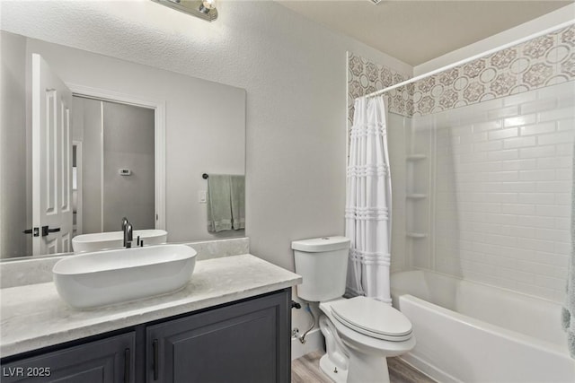 full bathroom featuring toilet, shower / bath combo, hardwood / wood-style flooring, and vanity