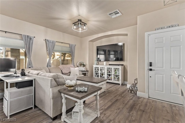 living room with dark hardwood / wood-style flooring