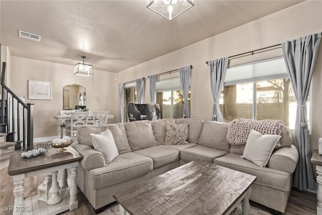 living room featuring hardwood / wood-style flooring and a chandelier