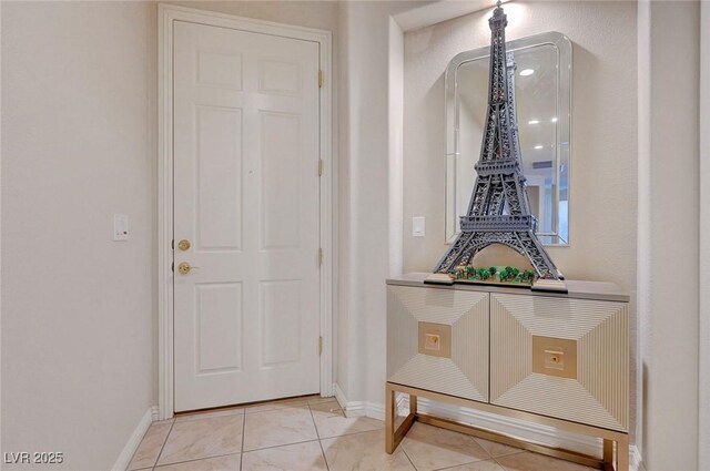 doorway featuring light tile patterned flooring