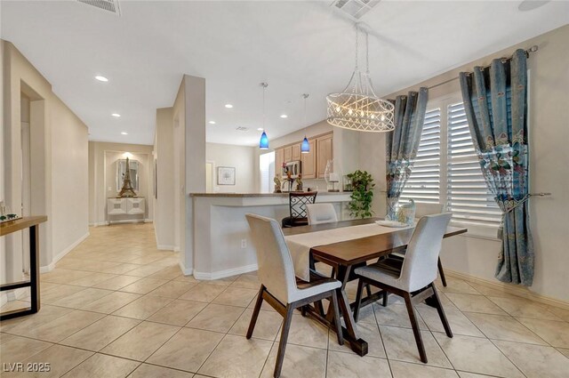 dining area with a wealth of natural light, light tile patterned floors, and a chandelier