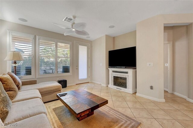 tiled living room with ceiling fan