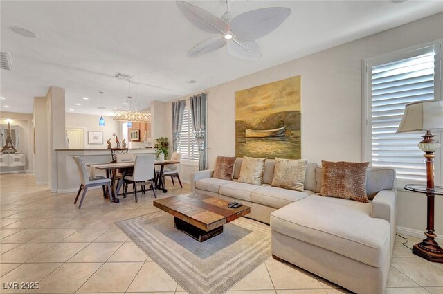 living room with ceiling fan and light tile patterned floors