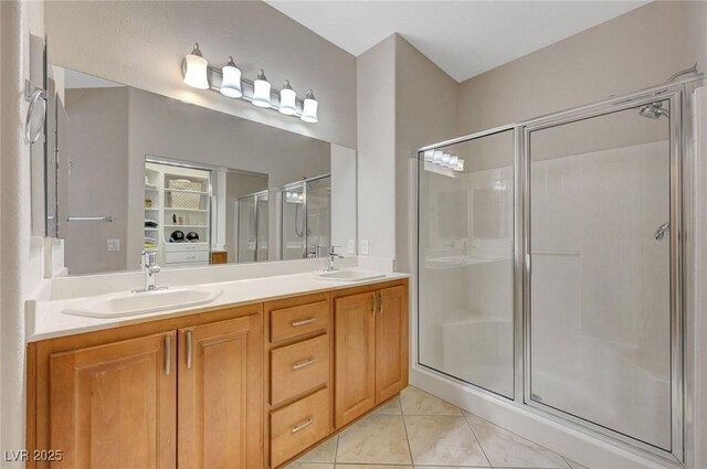 bathroom with vanity, tile patterned flooring, and walk in shower