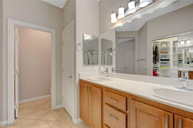 bathroom featuring toilet, vanity, and tile patterned floors