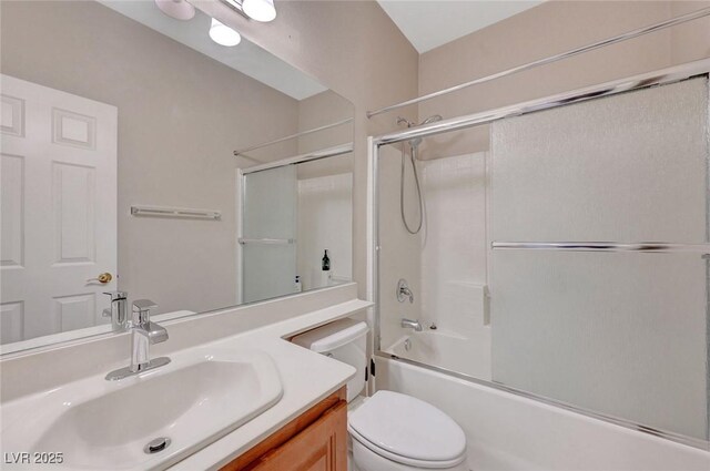 full bathroom with bath / shower combo with glass door, toilet, and vanity