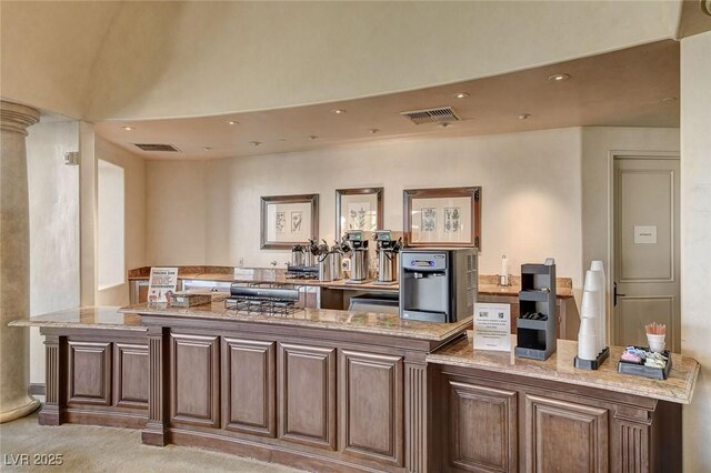 kitchen with light colored carpet and light stone countertops