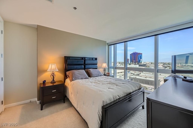 carpeted bedroom featuring floor to ceiling windows