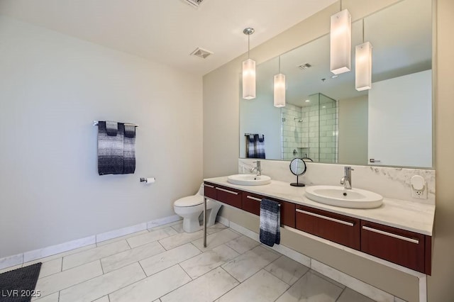 bathroom with toilet, a shower with shower door, and vanity