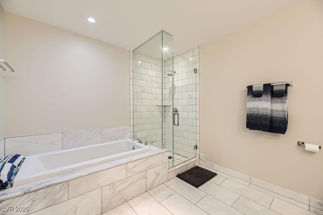 bathroom featuring tile patterned floors and separate shower and tub