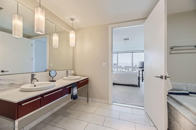 bathroom featuring tile patterned flooring, vanity, and a bathtub