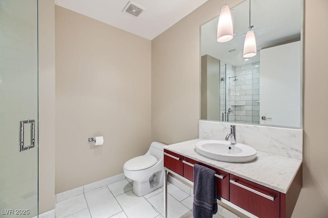 bathroom featuring a shower with shower door, tile patterned floors, vanity, and toilet