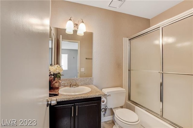 full bathroom with toilet, enclosed tub / shower combo, and vanity