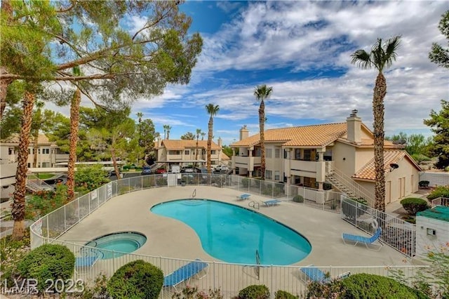 view of pool featuring a community hot tub and a patio