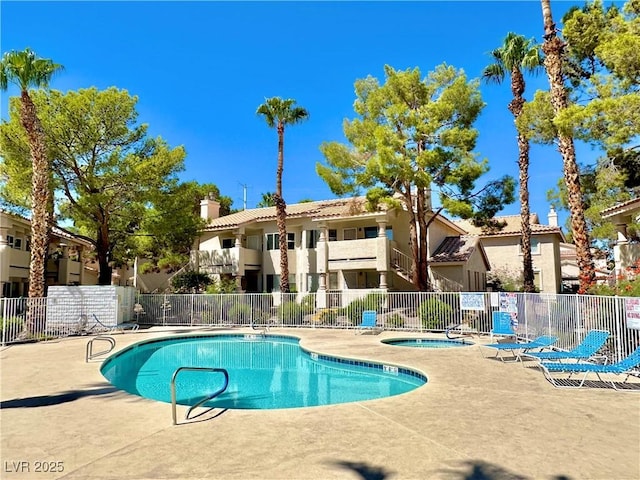 view of pool featuring a hot tub and a patio