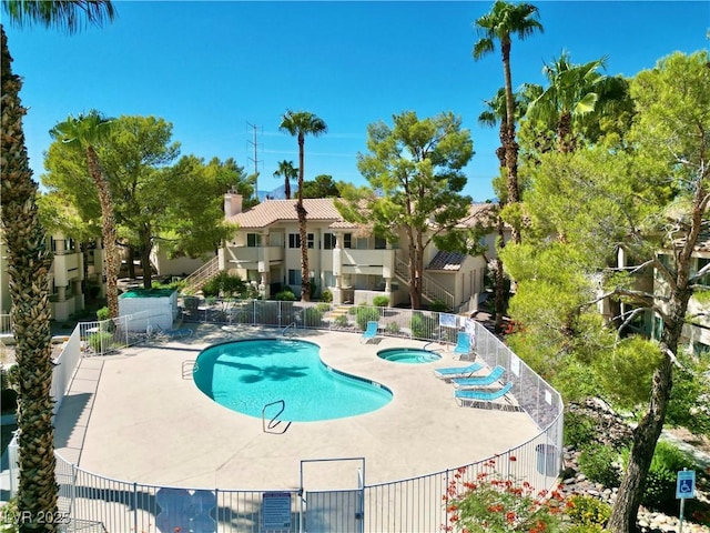 view of pool featuring a community hot tub and a patio area