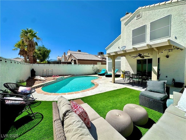 view of swimming pool with an outdoor living space, a patio area, a yard, and ceiling fan