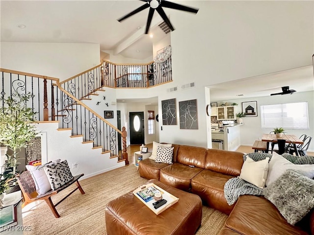 living room featuring a high ceiling, ceiling fan, and plenty of natural light