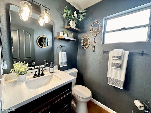 bathroom with toilet and vanity