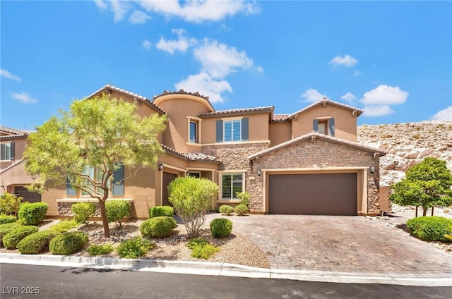 mediterranean / spanish-style home featuring a garage