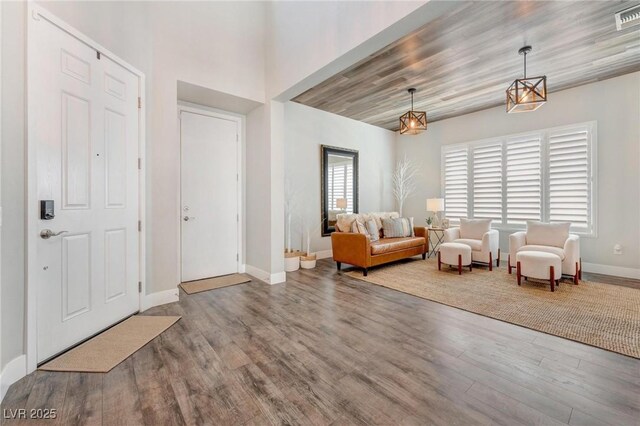 foyer entrance featuring wooden ceiling, a wealth of natural light, and wood-type flooring