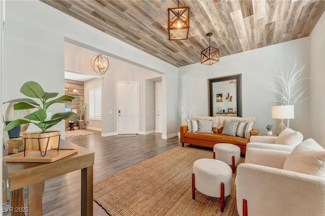 living room featuring wood-type flooring, wood ceiling, and a chandelier