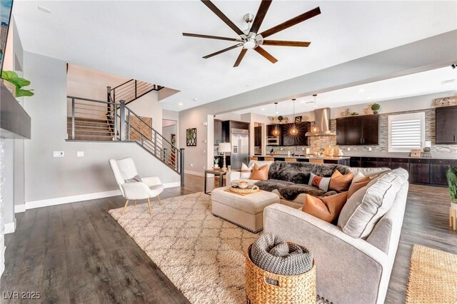 living room featuring ceiling fan and dark hardwood / wood-style flooring