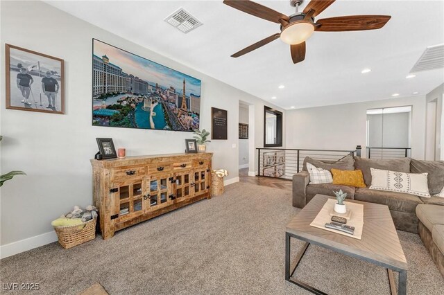 living room with ceiling fan and carpet flooring