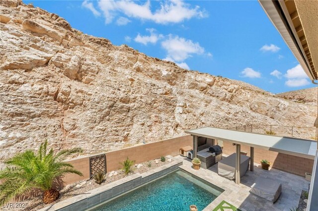 view of pool featuring a patio area and a mountain view