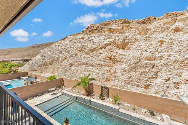 view of swimming pool with a mountain view