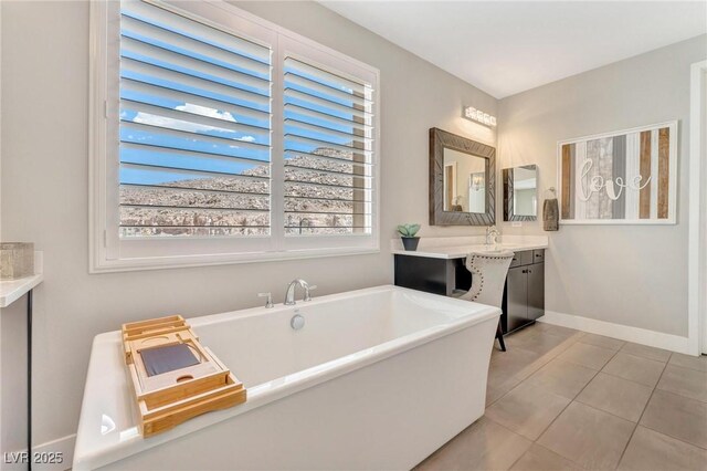 bathroom with sink, a bath, and tile patterned flooring