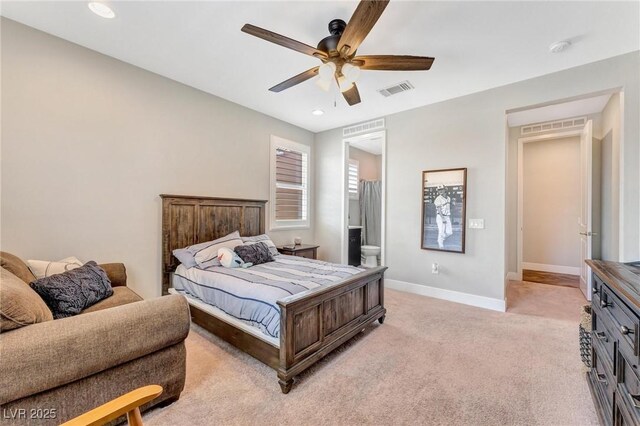 carpeted bedroom with ceiling fan and ensuite bath