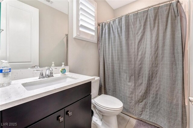 bathroom featuring toilet, vanity, tile patterned floors, and a shower with shower curtain