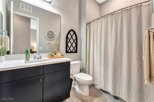 bathroom featuring toilet, tile patterned flooring, and vanity