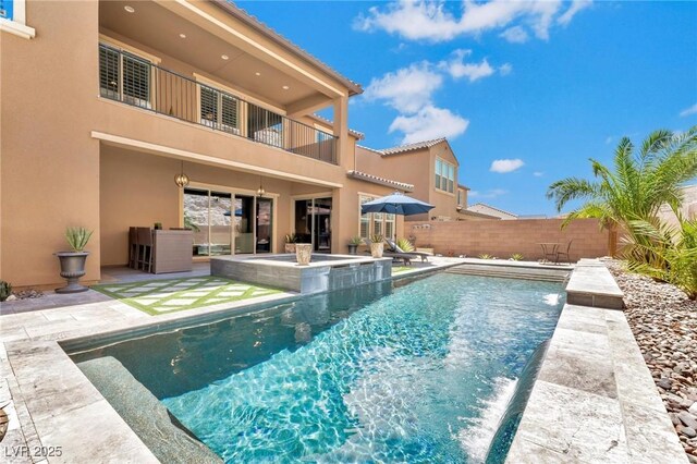 view of swimming pool with a patio area and pool water feature