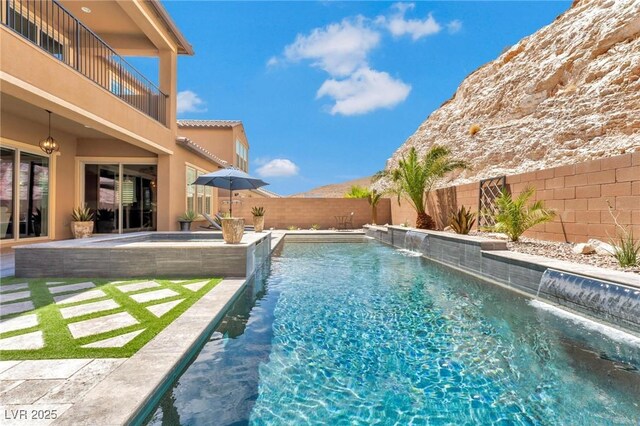 view of pool with pool water feature and a patio area