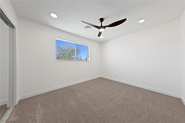 carpeted spare room with ceiling fan