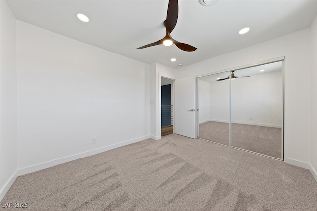 unfurnished bedroom with ceiling fan, a closet, and carpet floors