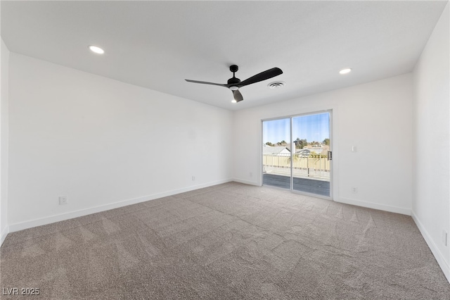 carpeted spare room with ceiling fan