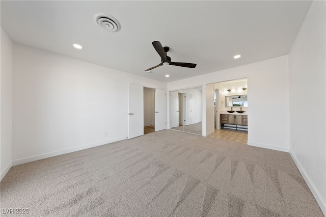 carpeted spare room with ceiling fan