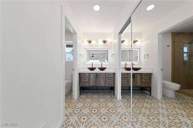 bathroom featuring toilet and vanity