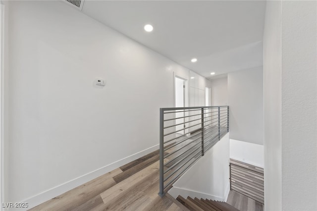 stairs featuring wood-type flooring