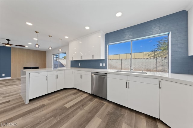 kitchen with dishwasher, decorative light fixtures, white cabinetry, kitchen peninsula, and ceiling fan