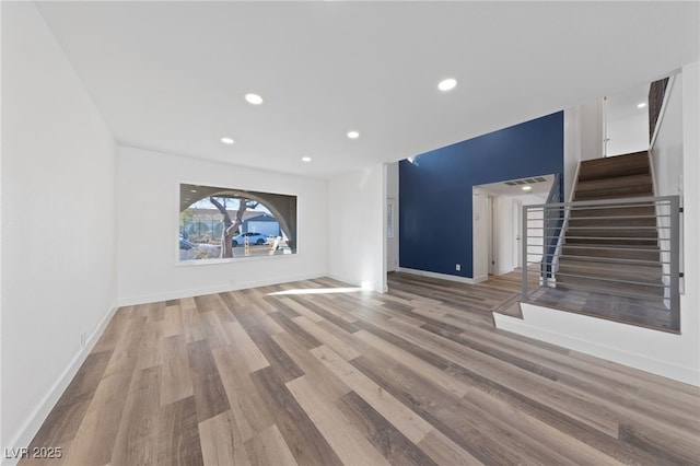 unfurnished living room featuring hardwood / wood-style flooring