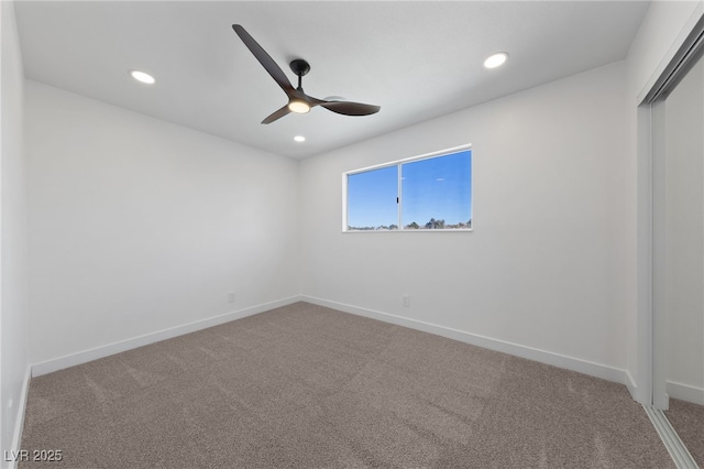 spare room with carpet and ceiling fan