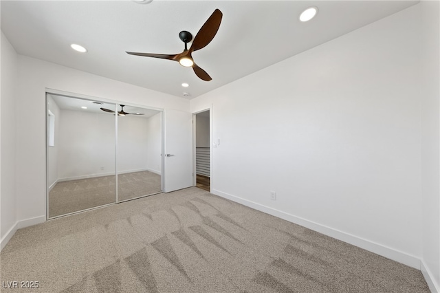 unfurnished bedroom featuring ceiling fan, a closet, and carpet floors