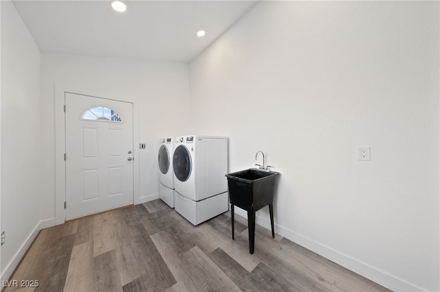 washroom featuring independent washer and dryer and light hardwood / wood-style flooring